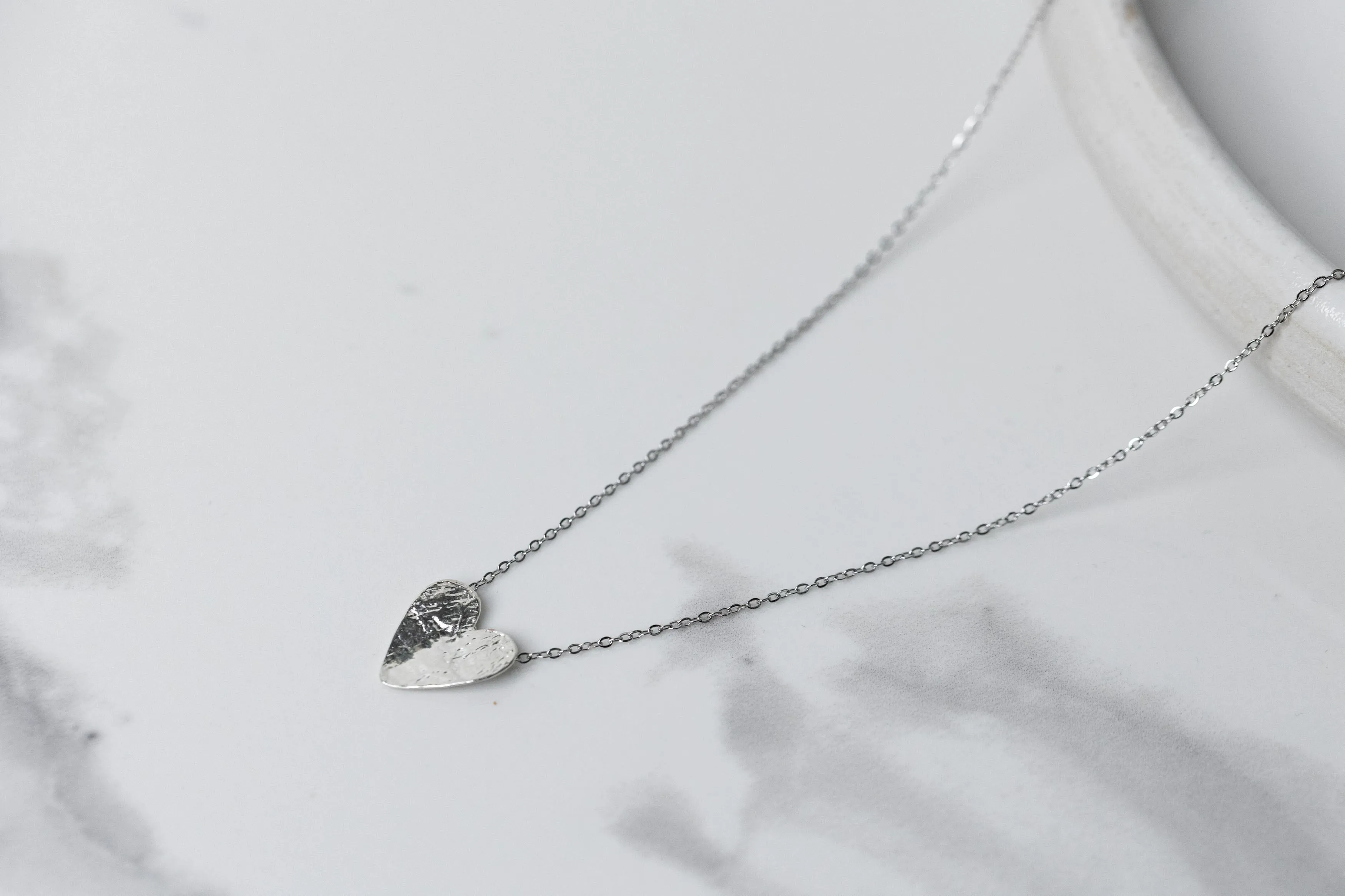 Silver semi-flip heart necklace