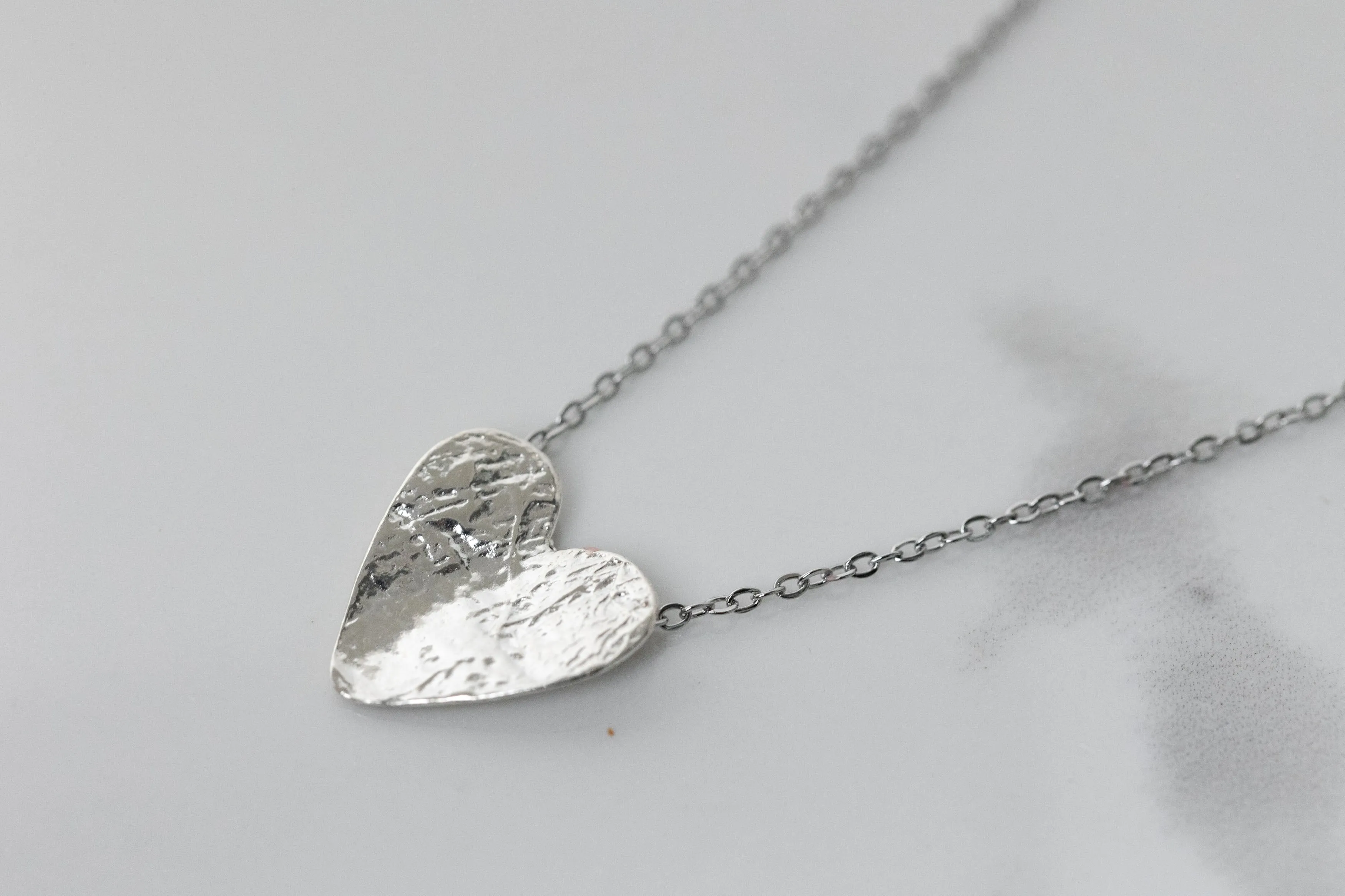 Silver semi-flip heart necklace